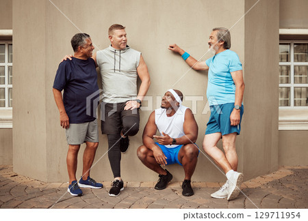 Happy men, fitness break and group exercise on wall background in urban city. Smile, sports training and male friends talking about workout, wellness support and team diversity of healthy lifestyle Happy men, fitness break and group exercise on wall background in urban city. Smile, sports training and male friends talking about workout, wellness support and team diversity of healthy lifestyle 129711954