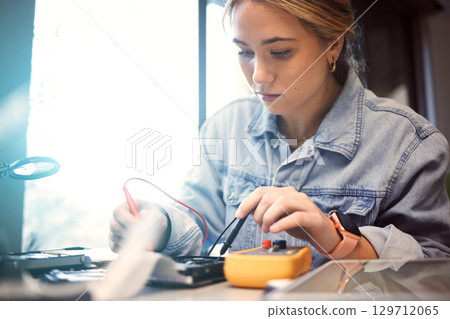 Engineer, student and woman repair electronics for science project. Learning, education and female technician with technology testing microchip, gadget or circuits for electricity with electric meter 129712065