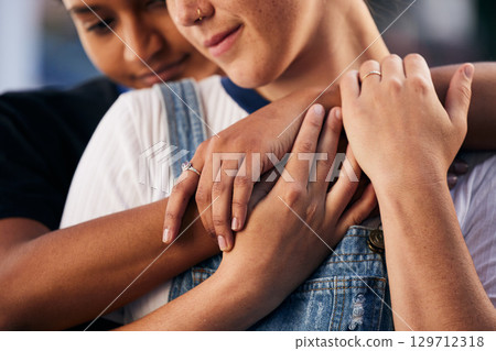 Hands, love and lgbt with a woman couple hugging outdoor for romance, dating or non binary affection. Hug, date and gay with a gender neutral female and partner sharing an intimate moment together 129712318
