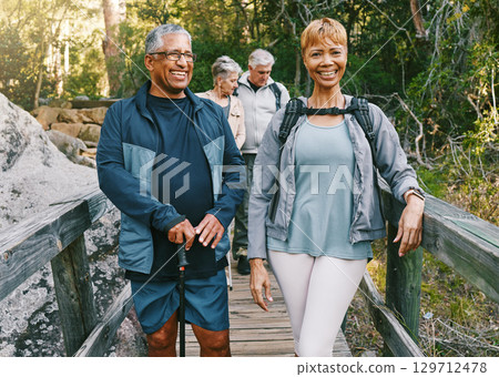 Portrait, hiking or couple of senior friends in nature trekking, walking or hiking for peace or freedom. Travel adventure, partnership or happy elderly people enjoy fun bonding, fitness or exercise Portrait, hiking or couple of senior friends in nature trekking, walking or hiking for peace or freedom. Travel adventure, partnership or happy elderly people enjoy fun bonding, fitness or exercise 129712478