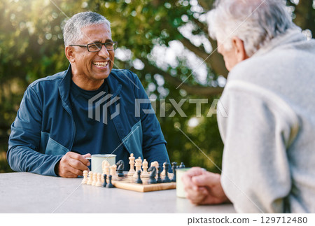 Chess, nature and retirement with senior friends playing a boardgame while bonding outdoor during summer. Park, strategy and game with a mature man and friend thinking about the mental challenge 129712480