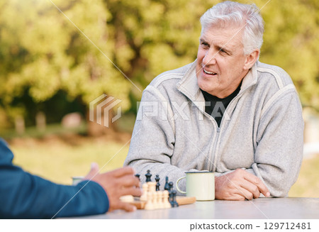 Chess, nature and retirement with senior friends playing a boardgame while bonding outdoor during summer. Park, strategy and game with a mature man and friend thinking about the mental challenge 129712481