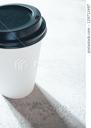 Coffee cup on the table, minimalistic design, disposable tableware, daylight, 129712497