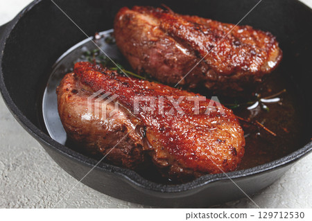 roast duck breast, in a frying pan, with spices and herbs, close-up, no people, 129712530