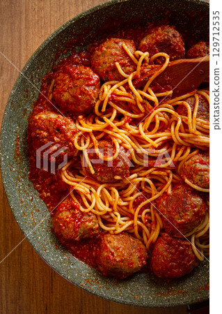 spaghetti with meatballs, in tomato sauce, cooking in a frying pan, no people, homemade, 129712535