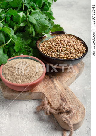 a bunch of fresh cilantro, coriander seeds and powder bowls, close-up, top view, no people, food and drinks, 129712541