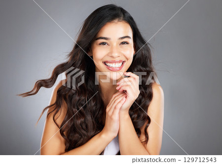 Hair care, woman and shine for beauty, natural glow and on grey studio background. Female, girl and hairstyle for wellness, confident and aesthetic for luxury grooming, treatment and salon routine. Hair care, woman and shine for beauty, natural glow and on grey studio background. Female, girl and hairstyle for wellness, confident and aesthetic for luxury grooming, treatment and salon routine. 129712543