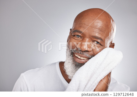 Skincare, portrait or old man with a face towel in studio with marketing or mock up space for beauty. Happy smile, glowing skin or healthy senior black man grooming with facial cosmetics or product Skincare, portrait or old man with a face towel in studio with marketing or mock up space for beauty. Happy smile, glowing skin or healthy senior black man grooming with facial cosmetics or product 129712648