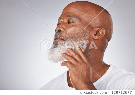 Senior black man, face and self care with skincare, dermatology and cosmetics for clean and fresh skin. Headshot of African male on grey studio background for beauty and beard hygiene and grooming 129712677