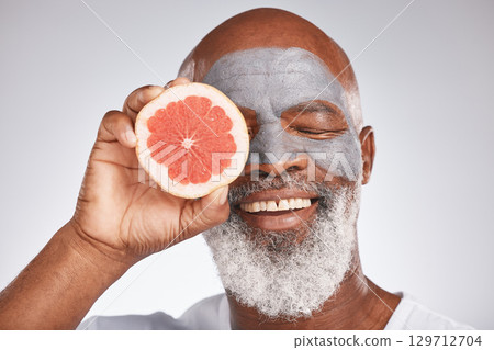 Skincare, face mask or happy old man with grapefruit marketing or advertising natural vegan diet for glowing skin. Cream, smile, senior black man with beauty or healthy anti aging facial cosmetics 129712704