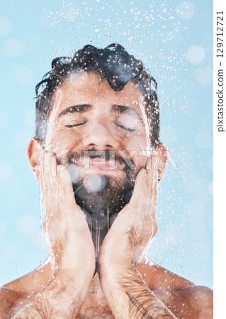 Wellness, water or man in shower cleaning skin or washing face and body in morning grooming routine in studio. Blue background, hands or healthy male model with self care, self love or a happy smile Wellness, water or man in shower cleaning skin or washing face and body in morning grooming routine in studio. Blue background, hands or healthy male model with self care, self love or a happy smile 129712721