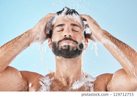 Shower, man and cleaning for skincare, wellness and hygiene on blue studio background. Arabic male, guy and wash face, hair and hydration for self care, health or body care for cleanliness or routine Shower, man and cleaning for skincare, wellness and hygiene on blue studio background. Arabic male, guy and wash face, hair and hydration for self care, health or body care for cleanliness or routine 129712755