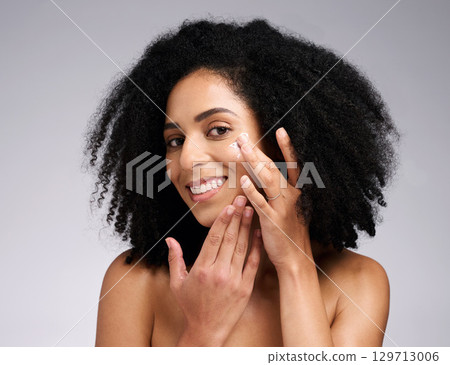 Portrait, skincare and black woman with cream, face detox and wellness on grey studio background. African American female, girl and lotion for organic facial, cosmetics and natural care for beauty. Portrait, skincare and black woman with cream, face detox and wellness on grey studio background. African American female, girl and lotion for organic facial, cosmetics and natural care for beauty. 129713006