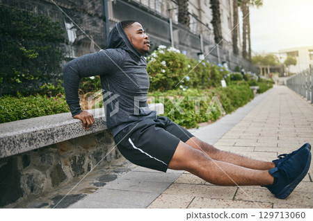 Exercise, triceps dips and black man in city, street or outdoors. Sports, thinking and young male athlete exercising, training and workout for muscle, strength and health, power or body care in town. 129713060