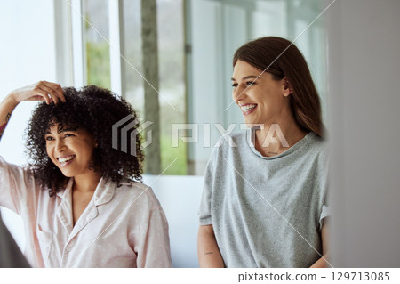 Friends, people or bonding in home grooming for hair care, skincare morning routine or healthcare wellness. Smile, happy women or girls bathroom beauty and mirror self love or luxury trendy hairstyle Friends, people or bonding in home grooming for hair care, skincare morning routine or healthcare wellness. Smile, happy women or girls bathroom beauty and mirror self love or luxury trendy hairstyle 129713085