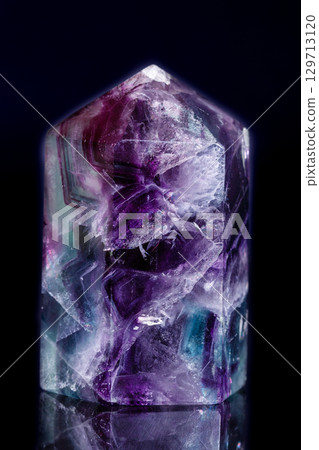 Macro mineral stone Fluorite crystal on a black background 129713120