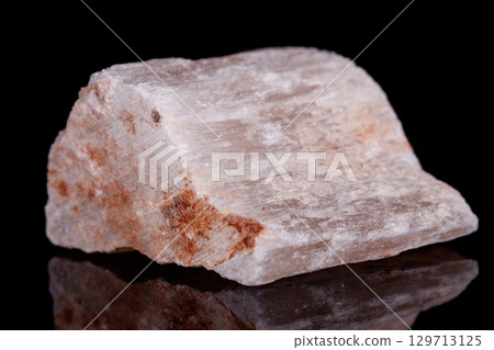 Macro mineral stone red gypsum on black background Macro mineral stone red gypsum on black background 129713125
