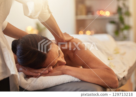 Woman at spa for massage with therapist and holistic treatment, wellness and self care with aromatherapy. Luxury service, health and peace with skincare to relax at salon, masseuse hands for zen. 129713218