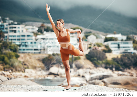 Yoga, balance and fitness with woman at the beach, pilates and zen in nature with exercise and body care outdoor. Workout by the ocean, stretching and peace with mindset and motivation for wellness. Yoga, balance and fitness with woman at the beach, pilates and zen in nature with exercise and body care outdoor. Workout by the ocean, stretching and peace with mindset and motivation for wellness. 129713262