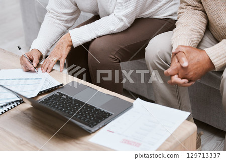 Laptop, budget and senior couple in living room for retirement research, investment planning or asset management. Elderly people hands, writing finance data for loan, mortgage and financial documents 129713337
