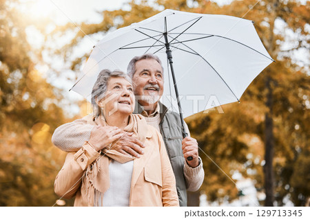 Senior couple, umbrella and walking outdoor for relax freedom, calm quality time and relationship bonding in summer. Elderly man, woman and wellness walk in countryside park together for love or care Senior couple, umbrella and walking outdoor for relax freedom, calm quality time and relationship bonding in summer. Elderly man, woman and wellness walk in countryside park together for love or care 129713345