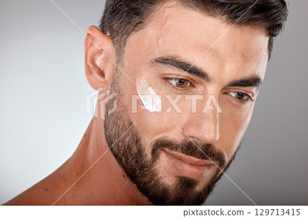 Man, face and cream for skincare and beauty closeup with sunscreen, facial treatment and moisturizer cosmetics. Lotion, healthy skin with wellness and glow, cosmetic care against studio background Man, face and cream for skincare and beauty closeup with sunscreen, facial treatment and moisturizer cosmetics. Lotion, healthy skin with wellness and glow, cosmetic care against studio background 129713415