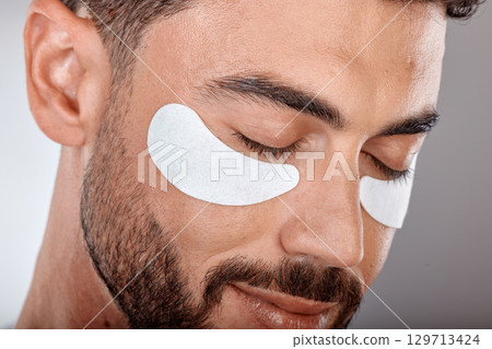 Skincare, beauty and man with mask for eyes on gray background for wellness, facial treatment and dermatology. Grooming, luxury spa and male with face patch, eye pads and cosmetics products in studio Skincare, beauty and man with mask for eyes on gray background for wellness, facial treatment and dermatology. Grooming, luxury spa and male with face patch, eye pads and cosmetics products in studio 129713424