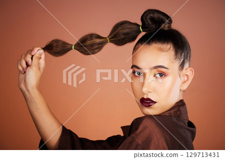 Hair, beauty with hair care and woman, makeup and cosmetics with lipstick, eye shadow and microblading against studio background. Portrait, long hair and healthy growth with glow and shine. 129713431