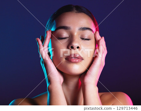 Woman, skincare and dark studio with eyes closed for beauty, makeup or self love with light on face. Model, natural cosmetic glow or skin wellness for self care, hands and health by studio background Woman, skincare and dark studio with eyes closed for beauty, makeup or self love with light on face. Model, natural cosmetic glow or skin wellness for self care, hands and health by studio background 129713446