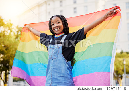 Black gay woman, rainbow flag and lgbtq pride with a smile for sexuality freedom, non binary and gender neutral lifestyle. Portrait of young lesbian girl in city of France for equality and love 129713448