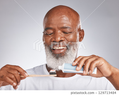 Dental, toothbrush and product with face of black man for oral hygiene, teeth cleaning and self care. Beauty, cosmetics and grooming with senior model and toothpaste for brushing teeth and health Dental, toothbrush and product with face of black man for oral hygiene, teeth cleaning and self care. Beauty, cosmetics and grooming with senior model and toothpaste for brushing teeth and health 129713484