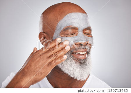 Skincare, face or senior black man with cream marketing or advertising a luxury beauty product for self care. Studio background, cosmetics or African old man with a happy smile applying facial mask Skincare, face or senior black man with cream marketing or advertising a luxury beauty product for self care. Studio background, cosmetics or African old man with a happy smile applying facial mask 129713485