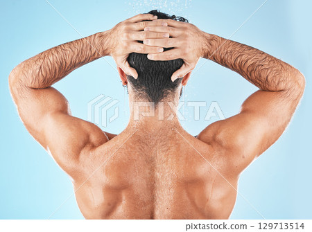 Water splash, man hair and shower for body hygiene, skincare grooming or cleaning care in blue background studio. Model back, self care water cleansing and cosmetics hair care wellness in morning Water splash, man hair and shower for body hygiene, skincare grooming or cleaning care in blue background studio. Model back, self care water cleansing and cosmetics hair care wellness in morning 129713514