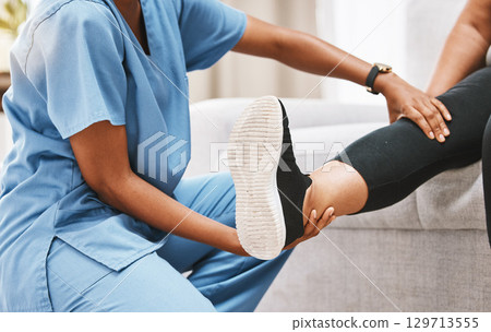 Leg, physiotherapy and rehabilitation with a nurse and patient recovering from knee pain or injury. Disability, rehab and recovery with a healthcare professional examing the joint of a female at home 129713555