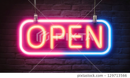 Striking OPEN neon sign, glowing in vibrant pink, blue hues, hangs against textured dark brick wall. Luminous sign creates welcoming and inviting atmosphere, signifying business is ready for customers 129713566