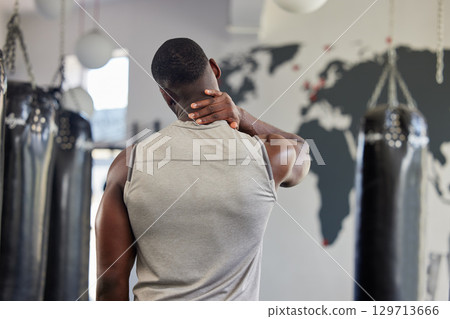 Fitness, neck pain and massage with black man in gym for training, workout and exercise. Injury, strain and physical therapy with athlete training in sports center for muscle, endurance and power Fitness, neck pain and massage with black man in gym for training, workout and exercise. Injury, strain and physical therapy with athlete training in sports center for muscle, endurance and power 129713666