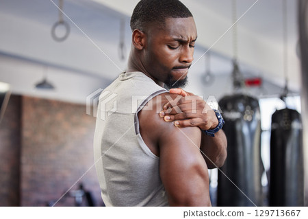 Exercise, black man and shoulder pain for training, fitness and workout for wellness in gym. Nigerian male, athlete and body care with pain, tired and injury for ache, strong and orthopedic problem 129713667