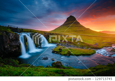 The Kirkjufellsfoss waterfall the coast of Snaefellsnes peninsula. Location Iceland. 129713745
