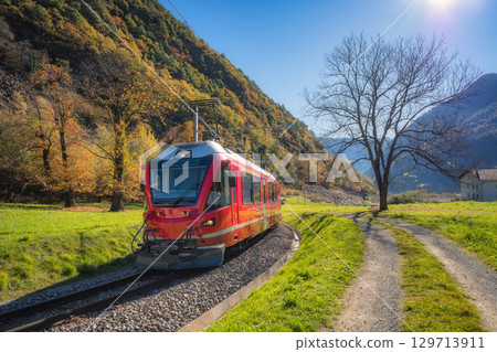 Bernina Express train in sunny autumn valley, Switzerland 129713911
