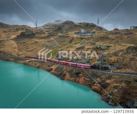 Aerial view of Bernina Express train near lake in Switzerland 129713938