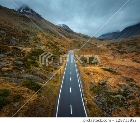 Aerial view of winding mountain road in the Swiss Alps in autumn 129713952