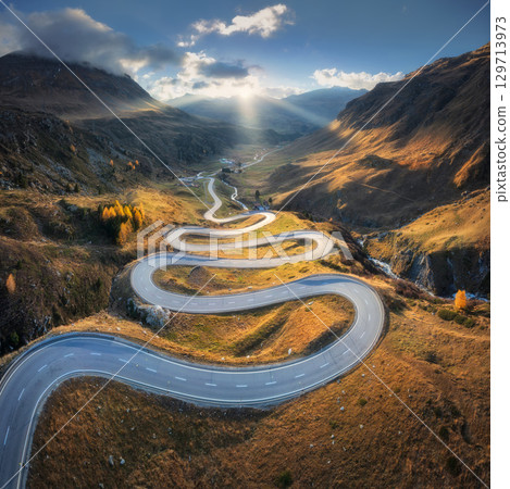 Aerial view of winding mountain road in the Swiss Alps 129713973