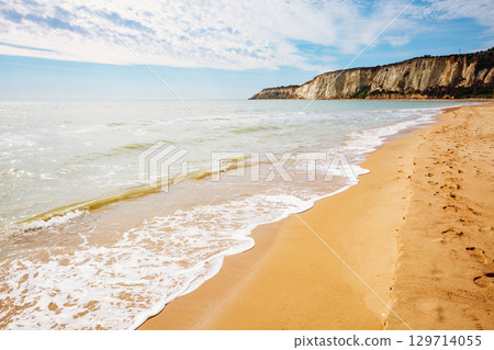 Breathtaking sea with white fluffy clouds. Outdoor vacation. 129714055
