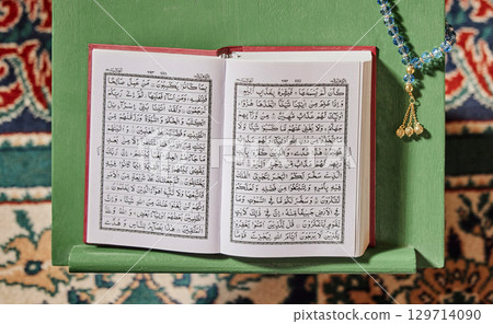 Quran, prayer beads and mosque with an open book and a rosary in an empty holy room or temple ready for praying. Islamic misbaha, tasbih or sibha and scripture in a muslim place of worship for eid Quran, prayer beads and mosque with an open book and a rosary in an empty holy room or temple ready for praying. Islamic misbaha, tasbih or sibha and scripture in a muslim place of worship for eid 129714090