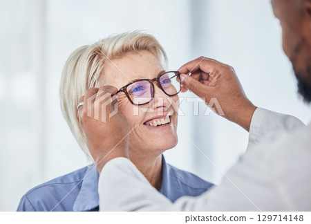 Vision, glasses with doctor and patient, eyes health and optometry, senior woman with black man at clinic. Eye exam, ophthalmology and health insurance with happy customer, consultation and glaucoma. Vision, glasses with doctor and patient, eyes health and optometry, senior woman with black man at clinic. Eye exam, ophthalmology and health insurance with happy customer, consultation and glaucoma. 129714148