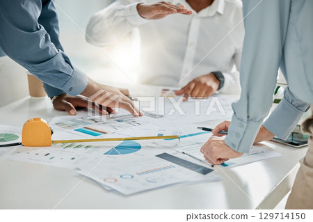 Paperwork, office and team planning a project together in conference room with graphs, data and statistics. Teamwork, documents and group of people in collaboration working on a strategy in workplace 129714150