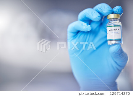 Innovation, healthcare or hand with vaccine, medicine or product in bottle with a blurry or blurred background. Monkey pox, doctor or scientist working on medical cure or lab drugs in safety gloves 129714270