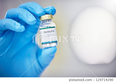 Innovation, healthcare or hand with vaccine, medicine or product in bottle with a blurry or blurred background. Monkey pox, doctor or scientist working on medical cure or lab drugs in safety gloves 129714290