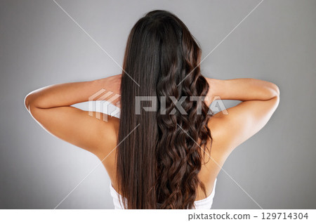 Woman back, curly or straight hairstyle on gray studio background for keratin treatment marketing, waves product advertising or grooming. Model, brunette color or healthy growth texture in wellness Woman back, curly or straight hairstyle on gray studio background for keratin treatment marketing, waves product advertising or grooming. Model, brunette color or healthy growth texture in wellness 129714304