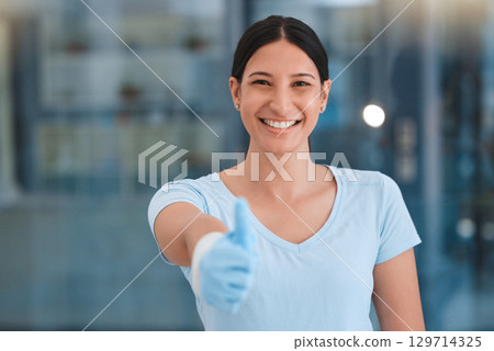 Cleaning woman, thumbs up portrait and office with smile, gloves and safety with happiness by blurred background. Happy hygiene expert, face and hand sign for motivation, goals and cleaning service 129714325